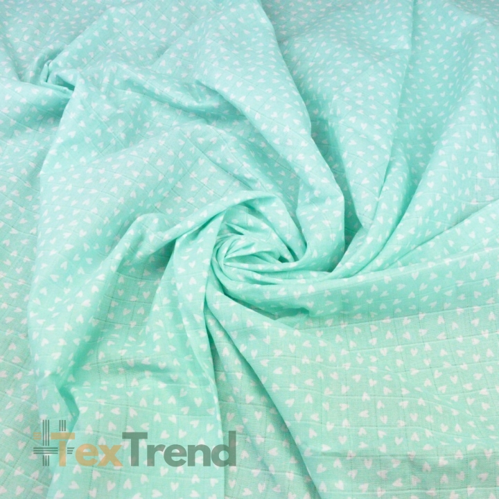 Baumwoll-Musselin mit Herzen auf mintfarbenem Hintergrund  