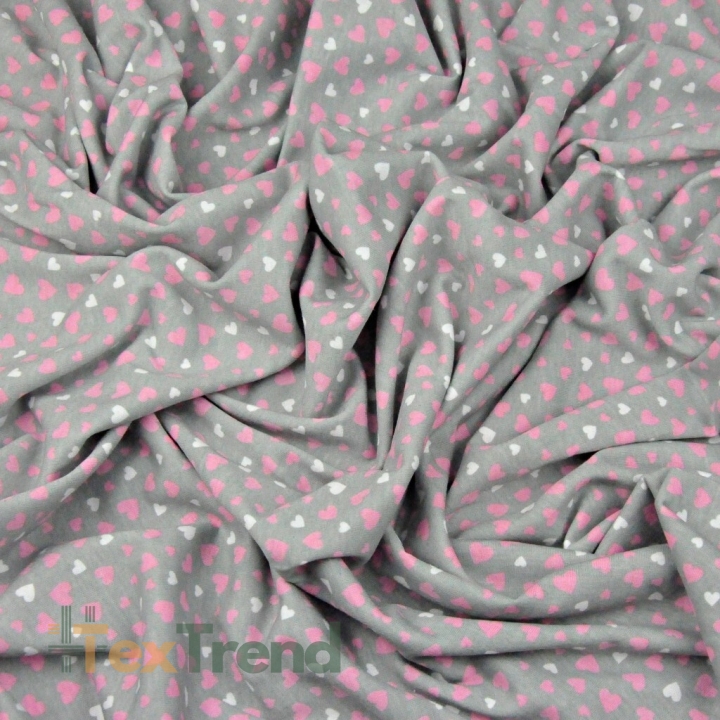 Jersey-Stoff mit rosa-weißen Herzen auf grauem Hintergrund  