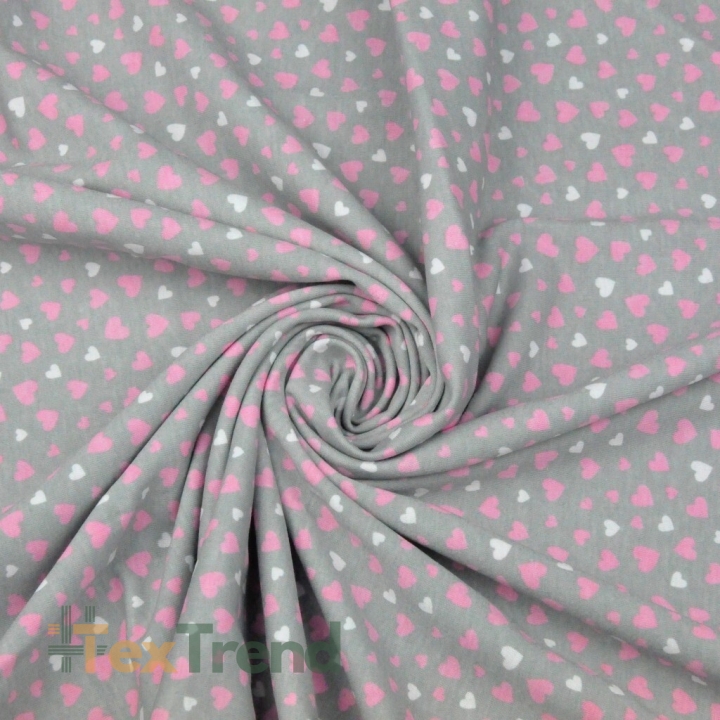 Jersey-Stoff mit rosa-weißen Herzen auf grauem Hintergrund  