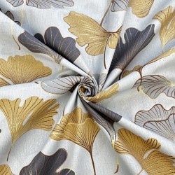 100% Baumwolle mit Ginkgo in grau-gold auf grauem Hintergrund  