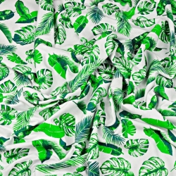 Jersey-Stoff mit grünen Blättern auf weißem Hintergrund  