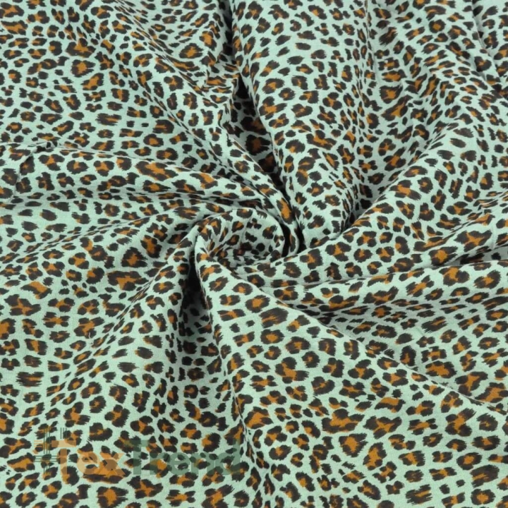 Baumwoll-Musselin plissiert Panther auf mintgrünem Hintergrund  