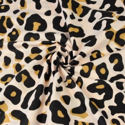 Baumwolle 100% Leopardenmuster braun-schwarz auf aprikosenfarbenem Hintergrund  