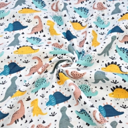 Baumwoll-Musselin mit bunten Dinosauriern auf weißem Hintergrund  