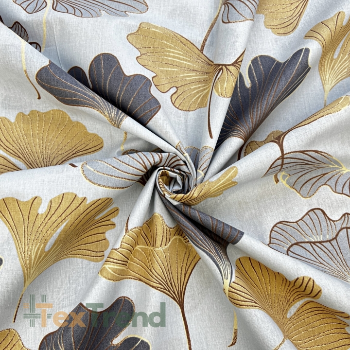 100% Baumwolle mit Ginkgo in grau-gold auf grauem Hintergrund  