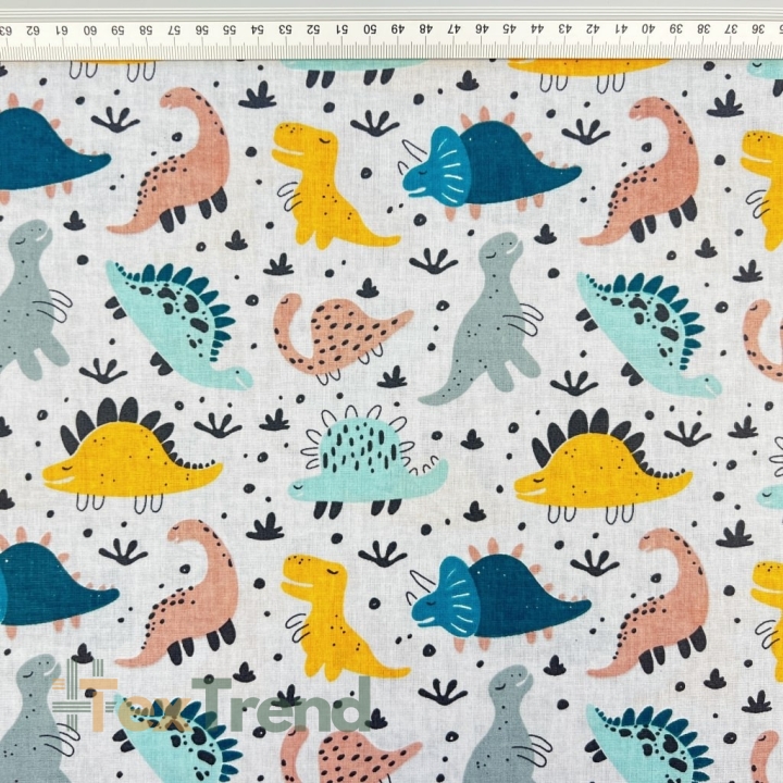 100% Baumwolle mit bunten Dinosauriern auf grauem Hintergrund  
