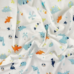 Musselin Double Gauze bedruckt mit orange-türkisen Dinosauriern und Palmen  