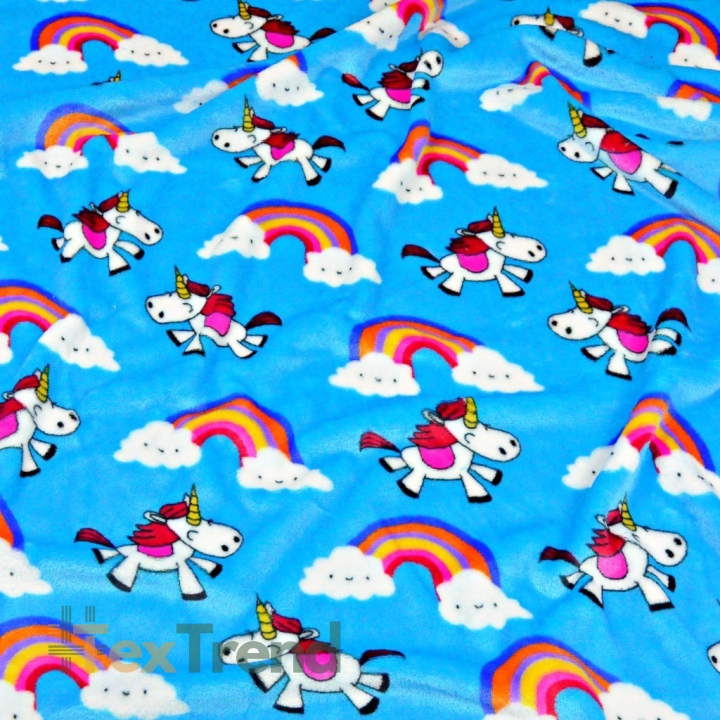 Kuschelfleece Stoff – Kinder Muster -  Einhörner mit Regenbogen auf blauem Hintergrund