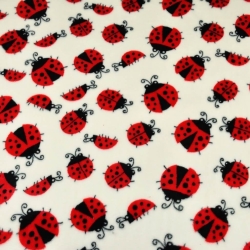 Kuschelfleece Stoff – Kinder Muster - Marienkäfer auf ecrufarbenem Hintergrund